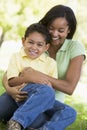 Woman and young boy outdoors embracing and smiling Royalty Free Stock Photo