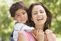 Woman and young boy outdoors embracing and smiling Royalty Free Stock Photo