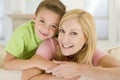 Woman and young boy sitting in living room smiling Royalty Free Stock Photo