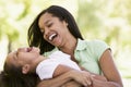 Woman and young girl outdoors embracing Royalty Free Stock Photo