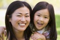 Woman and young girl outdoors embracing Royalty Free Stock Photo