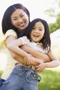 Woman and young girl outdoors embracing Royalty Free Stock Photo