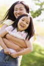 Woman and young girl outdoors embracing Royalty Free Stock Photo