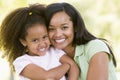 Woman and young girl outdoors embracing Royalty Free Stock Photo