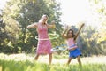 Woman and young girl outdoors using hula hoops Royalty Free Stock Photo