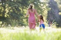 Woman and young girl running holding hands Royalty Free Stock Photo