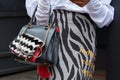 Woman with zebrine skirt and fur bag after Wunderkind fashion show, Milan Fashion Week street style on Royalty Free Stock Photo