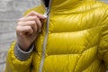 a woman zips up her jacket around her throat