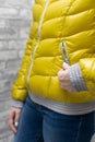 woman zips up the side pocket of her down jacket