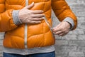 woman zips up the side pocket of her jacket