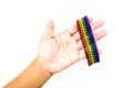 Womand hand holding a colorful spheres magnet bracelet