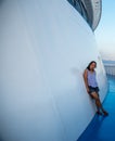 Woman leaning against wall on deck of ferry boat in Greece Royalty Free Stock Photo