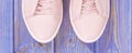 Pair of pink womanly leather shoes on old boards