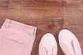 Womanly pink leather shoes and pants, copy space for text on rustic board