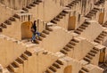 Womanm walking on stepwells of Chand Baori in Jaipur India.