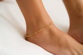 womans ankle with a dainty gold anklet