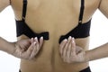 Womans back holding bra straps