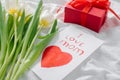 Womans day, mothers day concept. White tulips, gift present, greeting card with text I love mom Royalty Free Stock Photo