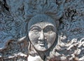 A Womans Face Carved in a Distressed Wood Root Ball.