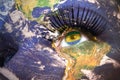 Womans face with planet Earth texture and gabonese flag inside the eye.