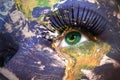 Womans face with planet Earth texture and mauritania flag inside the eye.