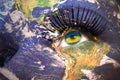 Womans face with planet Earth texture and rwandan flag inside the eye.
