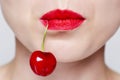 womans face with red lipstick and a cherry Royalty Free Stock Photo