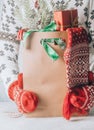 Womans hand carrying a paper shopping bag full of gift boxes Christmas ornamented