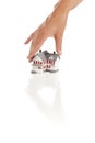 Womans Hand Choosing A Home on White