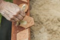 Womans hand cleaning with a brush, three pieces of pottery in a Royalty Free Stock Photo