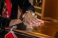 Womans hand with engagement ring opens big gold Christmas present - closeup and selective focus Royalty Free Stock Photo