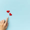 Womans hand with hearts on blue background. Summer nail design Royalty Free Stock Photo