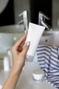 Womans hand holding cleansing foam in the bathroom Royalty Free Stock Photo