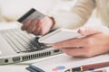 Womans hand holding credit card and smartphone Royalty Free Stock Photo