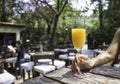 Womans hand holding a glass of orange juice