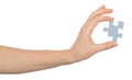 Womans hand holding puzzle piece Royalty Free Stock Photo