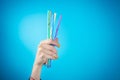 Womans hand holding straws