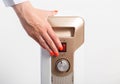 A womans hand presses the buttons to turn on an oil electric heater on a white background. The concept of heating Royalty Free Stock Photo