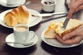 Womans Hand Spreads Butter on a PÃÂ£o de Deus Roll Royalty Free Stock Photo