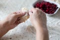 Womans hands cooking dumplings with cherries. Royalty Free Stock Photo