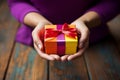 A womans hands hold a gift box