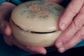 Womans hands holding old jewelry dish Royalty Free Stock Photo