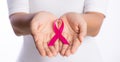 Womans hands holding pink breast cancer awareness ribbon on white background. healthcare and medicine concept Royalty Free Stock Photo