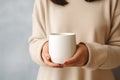 Womans hands holding a plan white blank mug cup, beige neutral rustric cottagecore Royalty Free Stock Photo