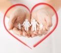 Womans hands with paper man family Royalty Free Stock Photo