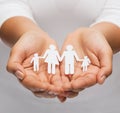 Womans hands with paper man family Royalty Free Stock Photo