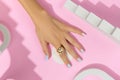 Womans hands with trendy manicure on pink background. Summer nail design