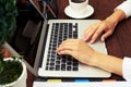 Womans hands using laptop on wooden table Royalty Free Stock Photo