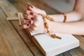 Womans hands with wooden rosary and Holy Bible Royalty Free Stock Photo