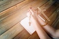 Womans hands with wooden rosary and Holy Bible Royalty Free Stock Photo